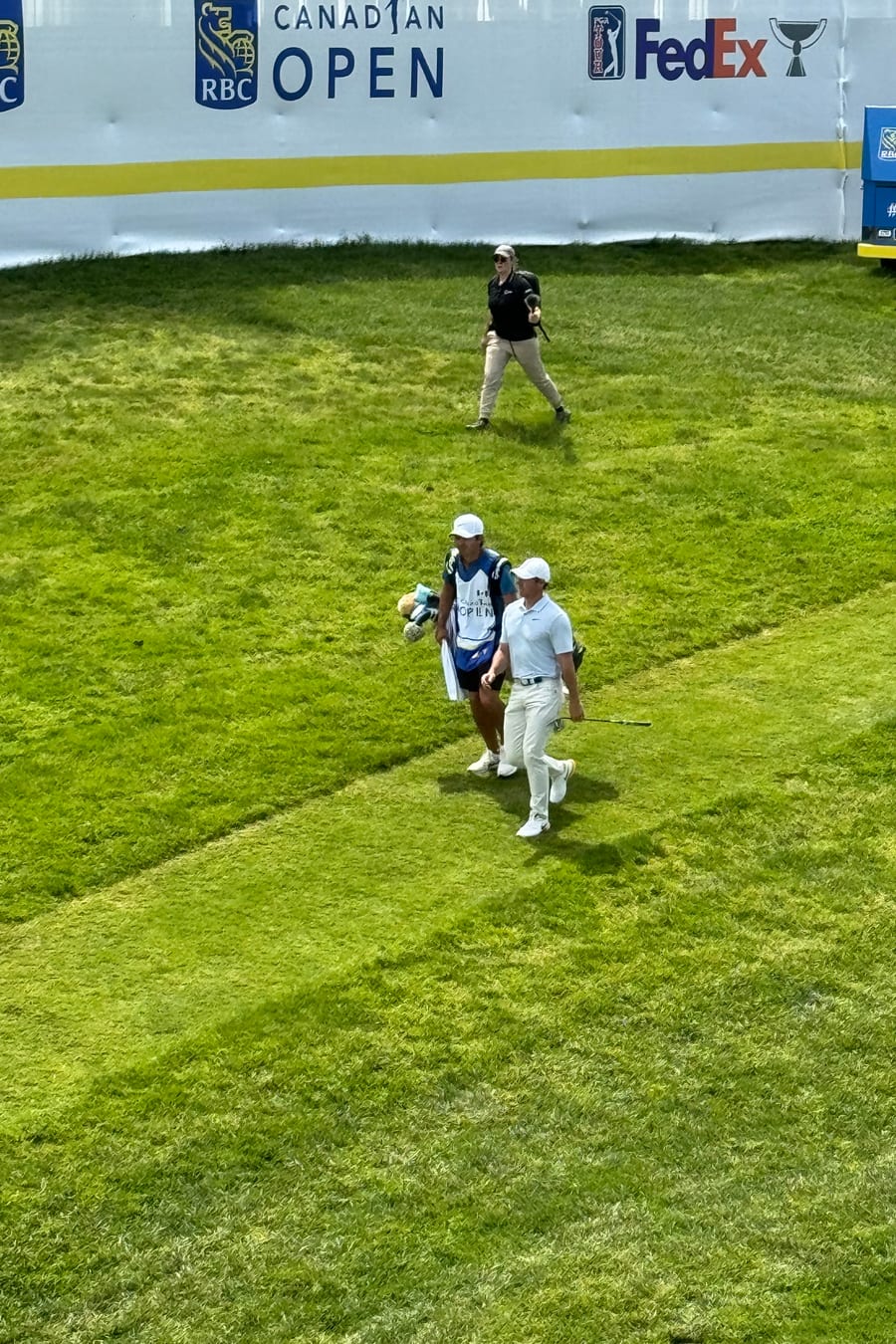 A player and caddie walking the fairway at the RBC Canadian Open 2024